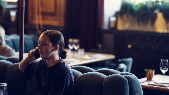 Woman in restaurant talking on the phone